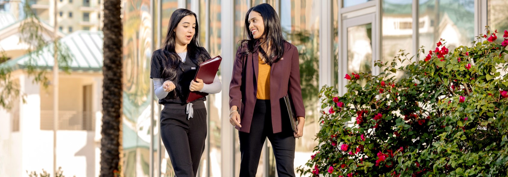 Faculty with student in Health North courtyard
